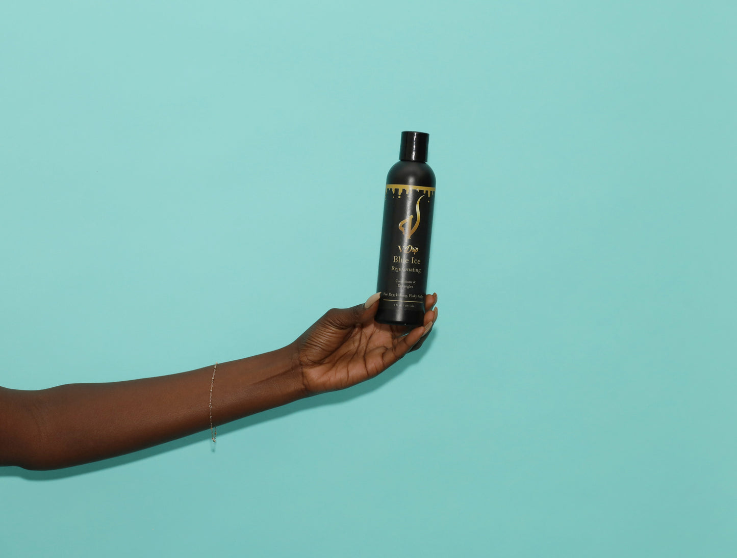 hand holding V Drip Blue Ice Rejuvinating Shampoo that condition and detangles hair